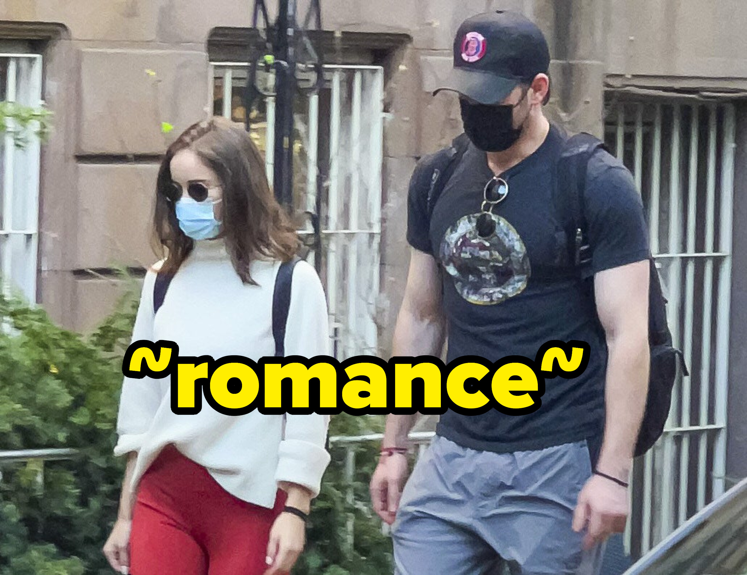 The couple, both wearing face masks, taking a walk