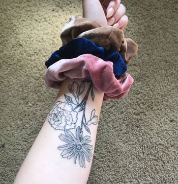 image of three velvet scrunchies on a reviewer's wrist