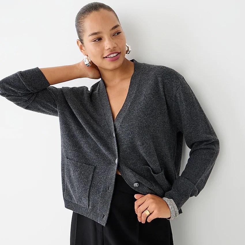 A model wearing grey cardigan with black pants