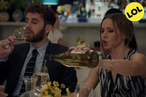 Kristen Bell and Ben Platt drink wine at a restaurant 