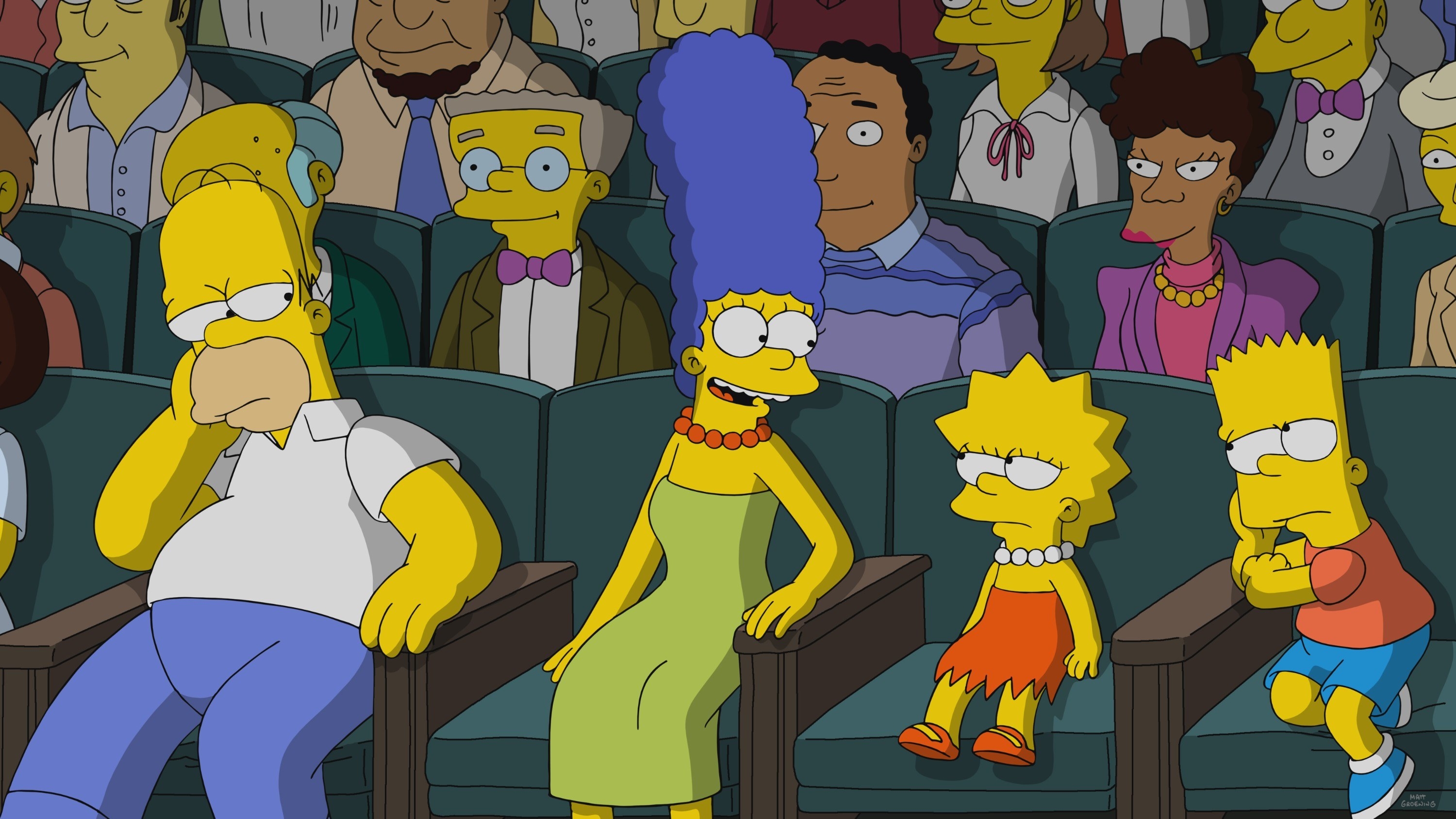 The Simpsons sitting in a movie theater