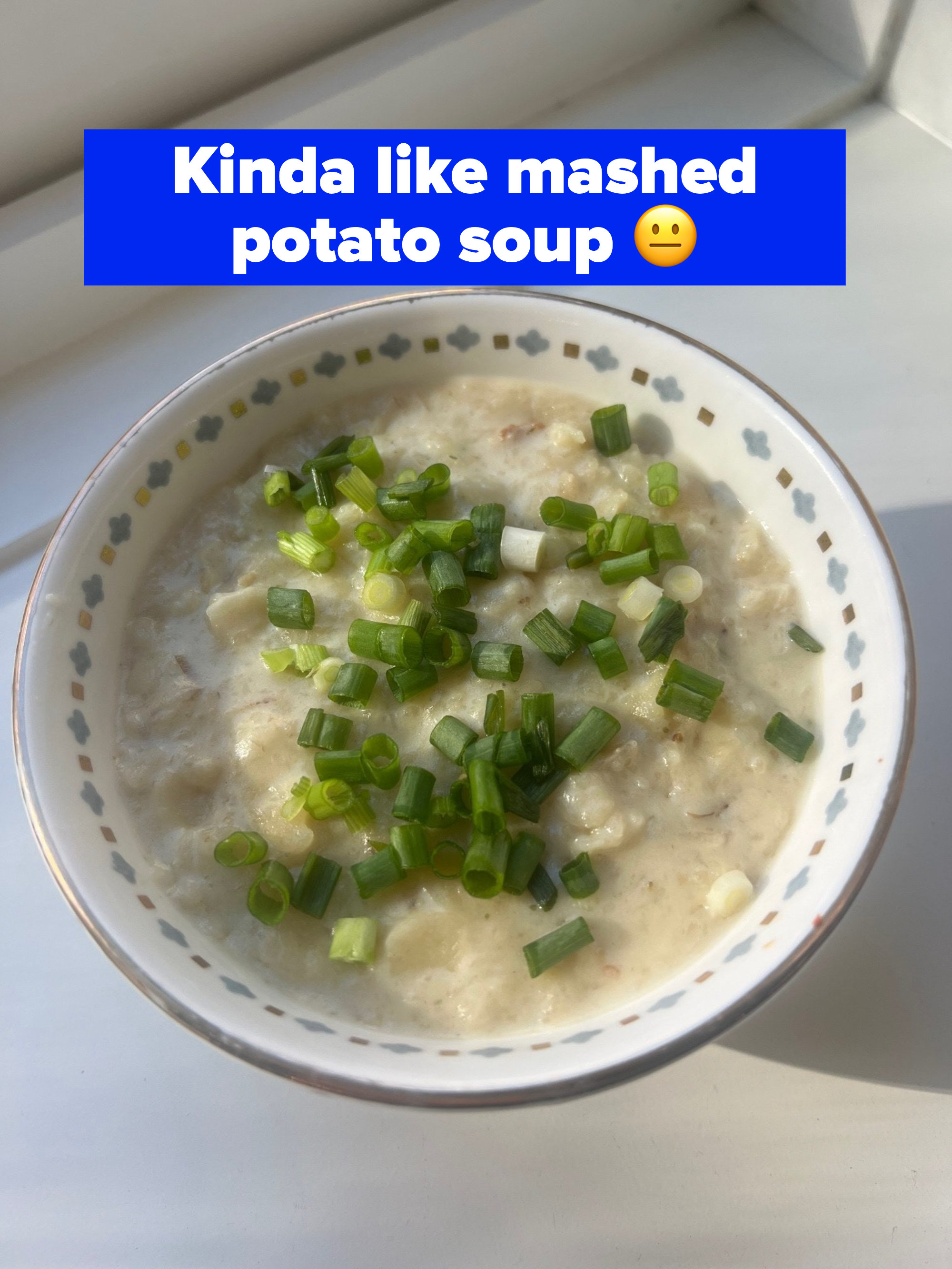 A bowl of mashed &quot;potatoes&quot; topped with green onions.