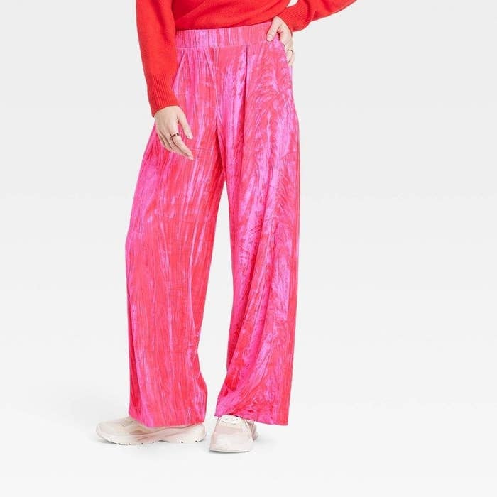 model wearing hot pink, crushed velvet wide leg pants