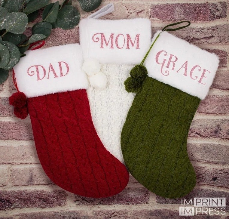 a red stocking labeled &quot;dad&quot;, a white one labeled &quot;mom&quot;, and a green one labeled &quot;grace&quot;