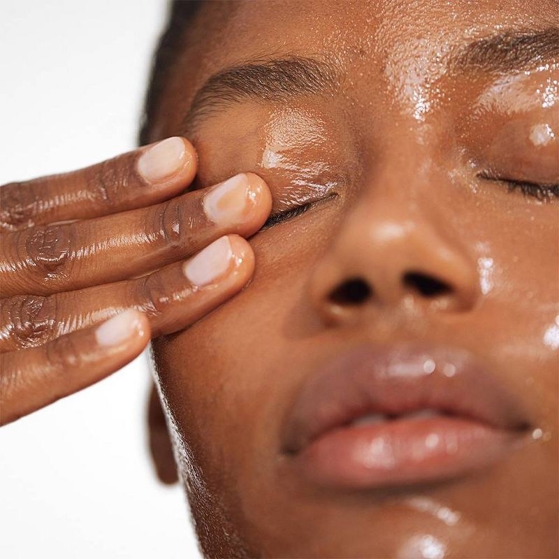 A person applying cleansing balm