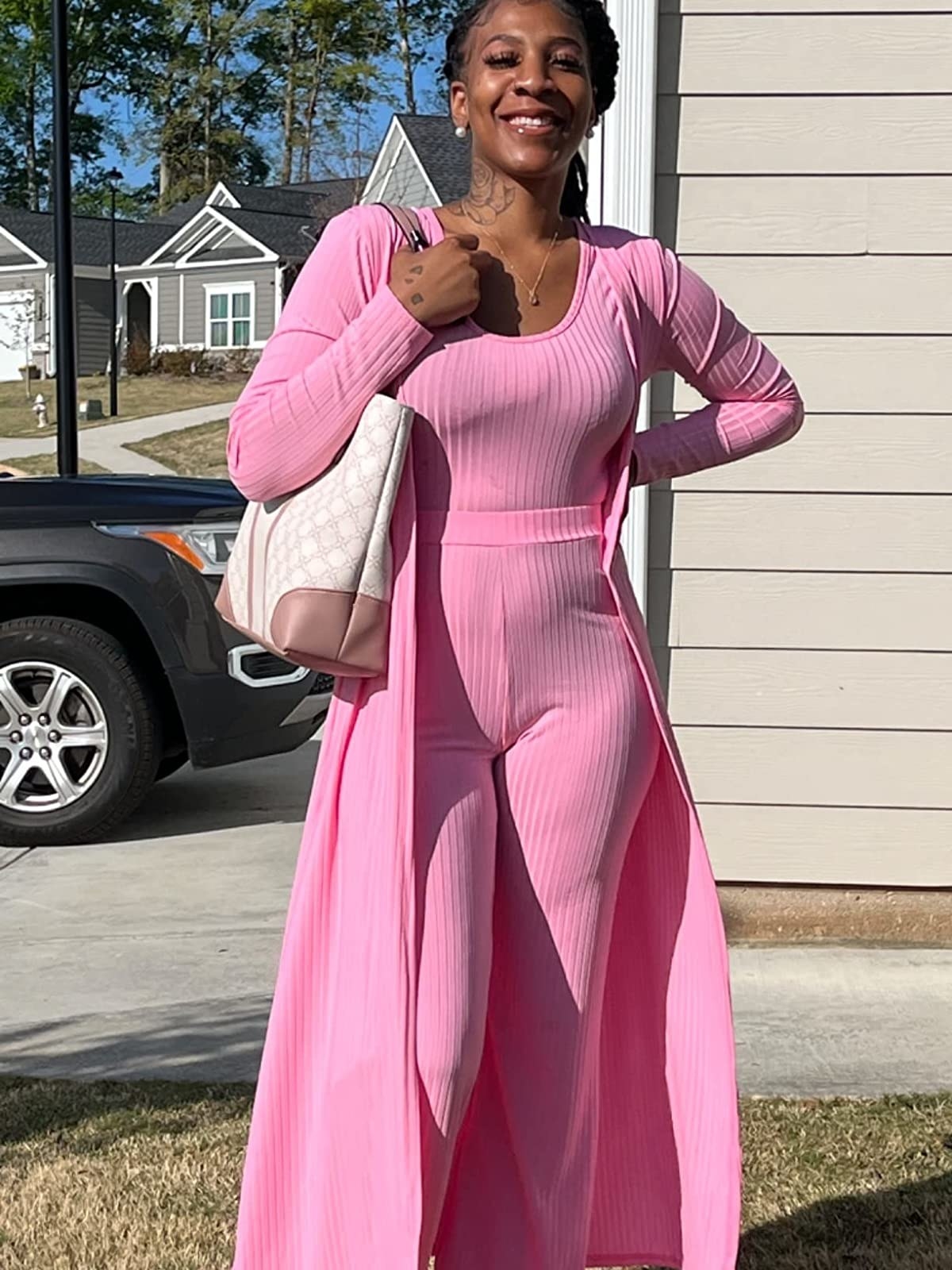 A reviewer wearing a pink set