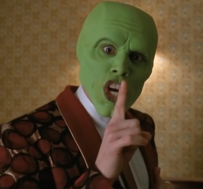 Jim Carrey as the mask holding his finger to his mouth to be quiet