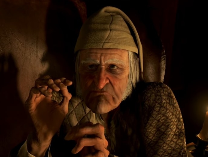 An animated version of Jim Carrey as Ebenezer Scrooge frowning in a chair
