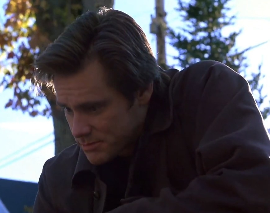 Jim Carrey as an adult version of Joe looking down at Simons gravestone