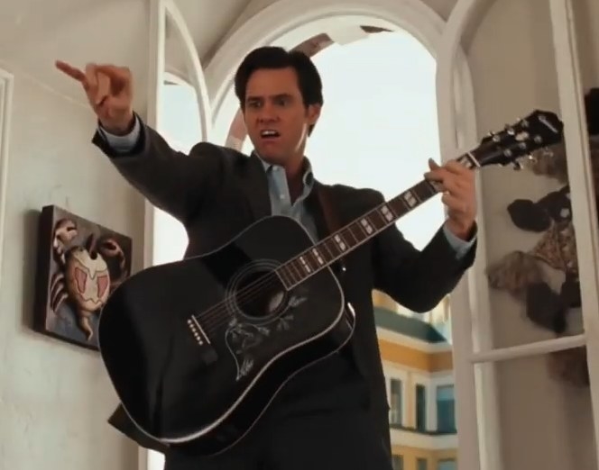 Jim Carrey as Carl playing a guitar