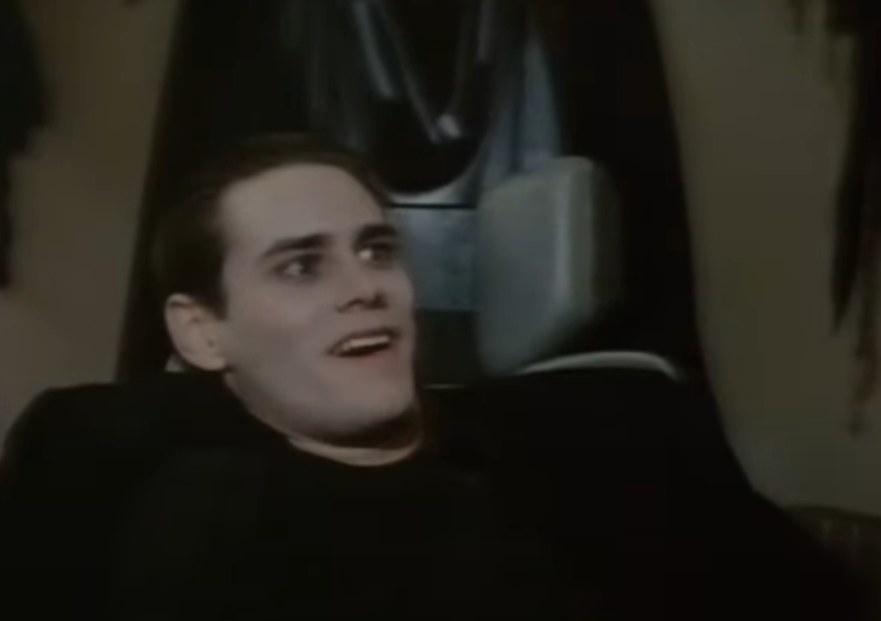 Jim Carrey as Mark sinking into a chair