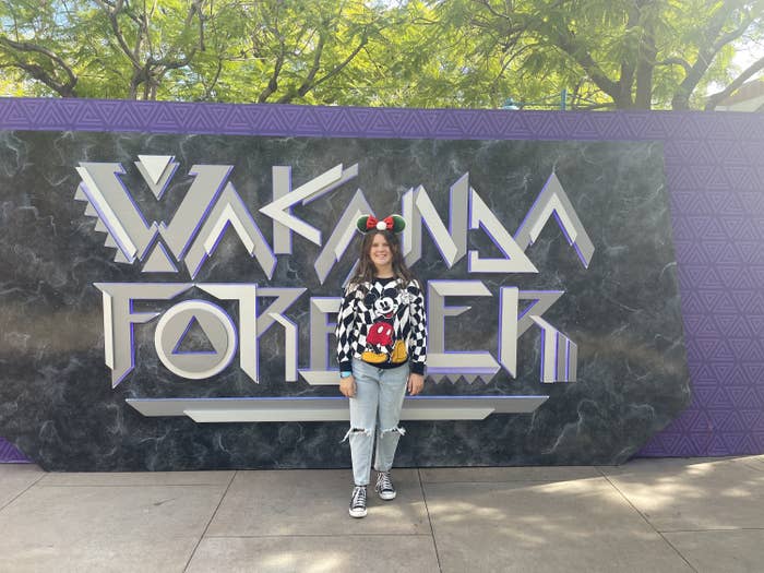 the author's daughter standing by the Wakanda Forever wall