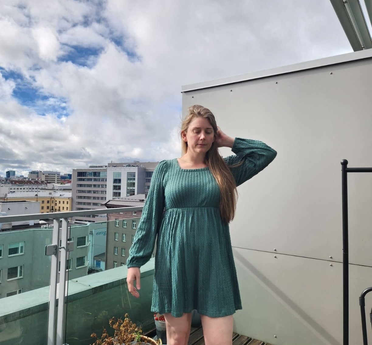 Reviewer standing outside in the teal dress