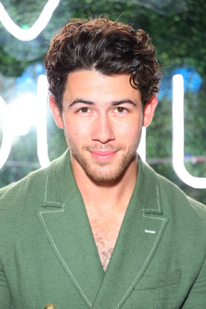 Nick Jonas smiling at an event