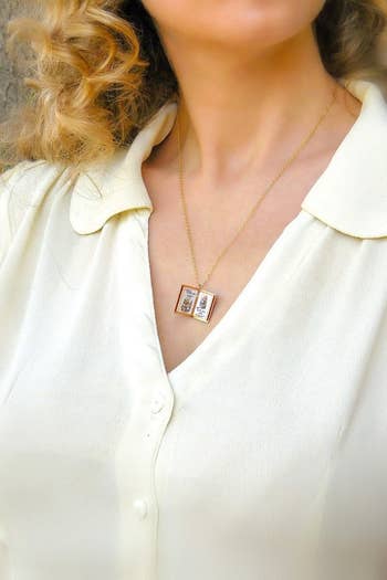 model wearing a book pendant necklace