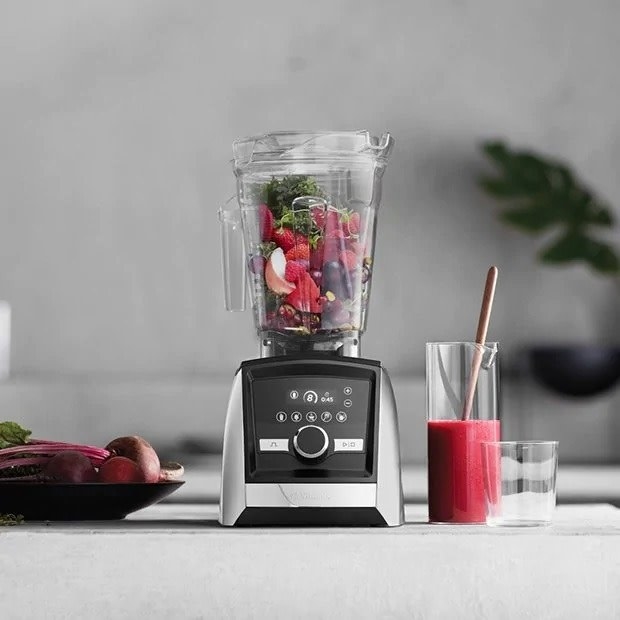 The Vitamix on a counter next to a smoothie
