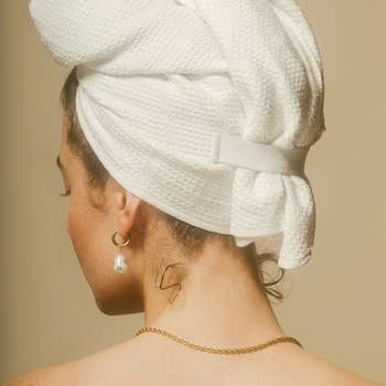 model with their hair wrapped up in the towel