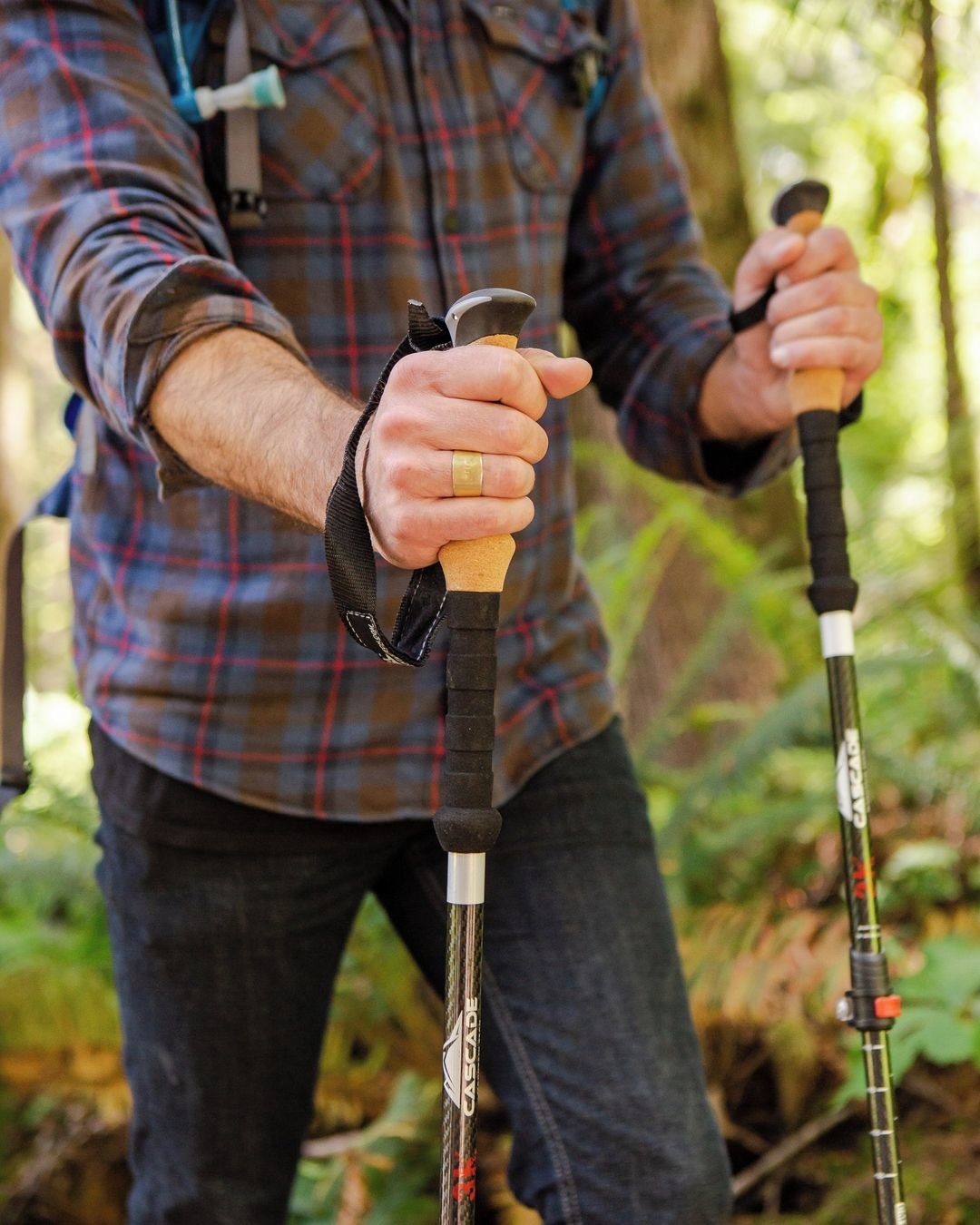 person using the cork grip version of the poles in a forest