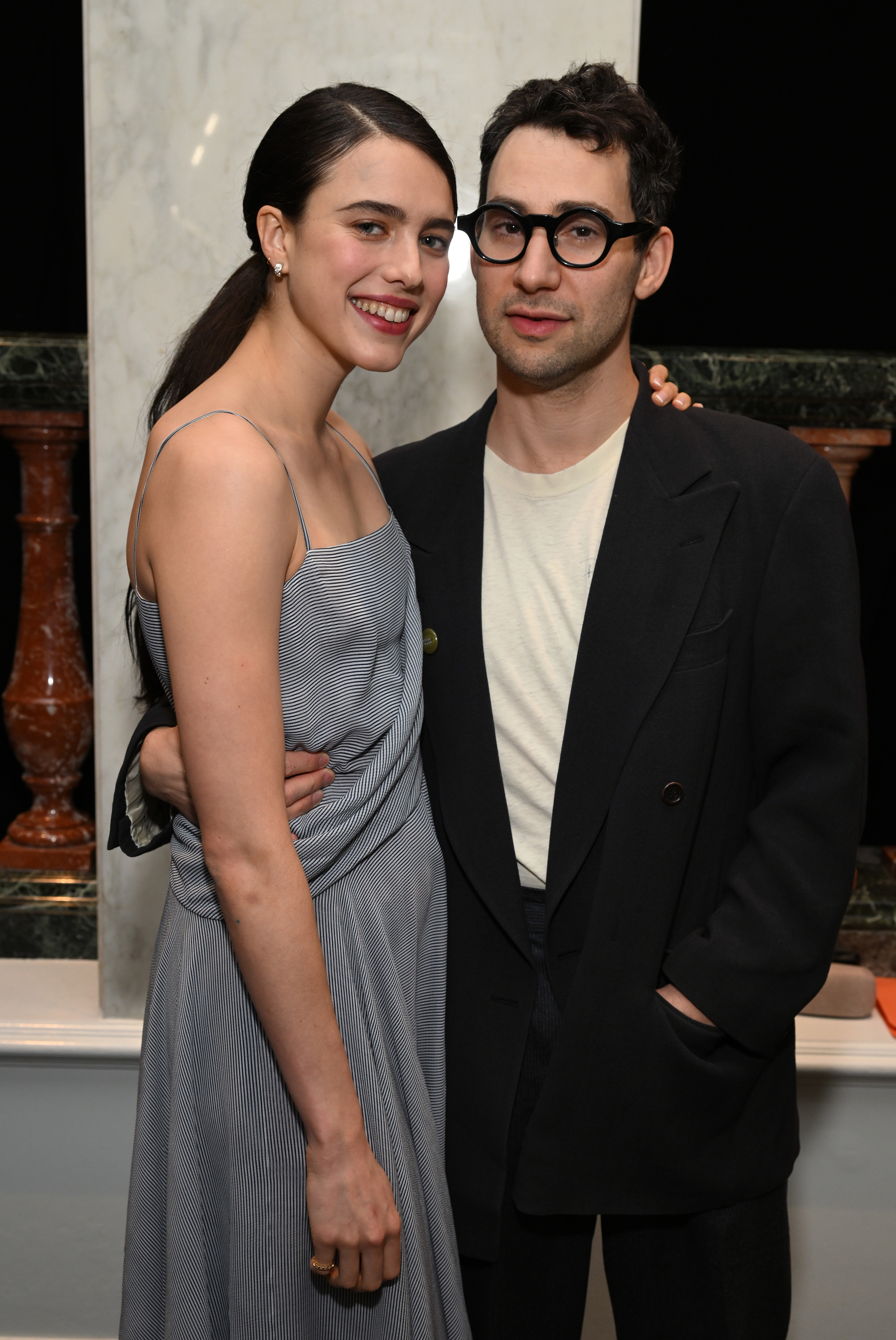Margaret Qualley and Jack Antonoff smiling with their arms around each other