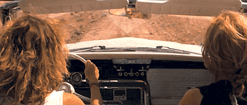 thelma and louise hold hands whilst preparing to drive off a cliff