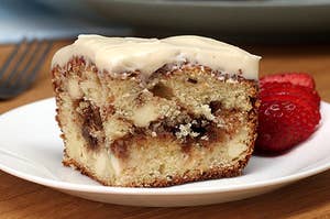 Photo of a cinnamon bun snacking cake on a white plate
