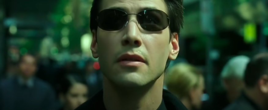 A man wearing sunglasses looks up
