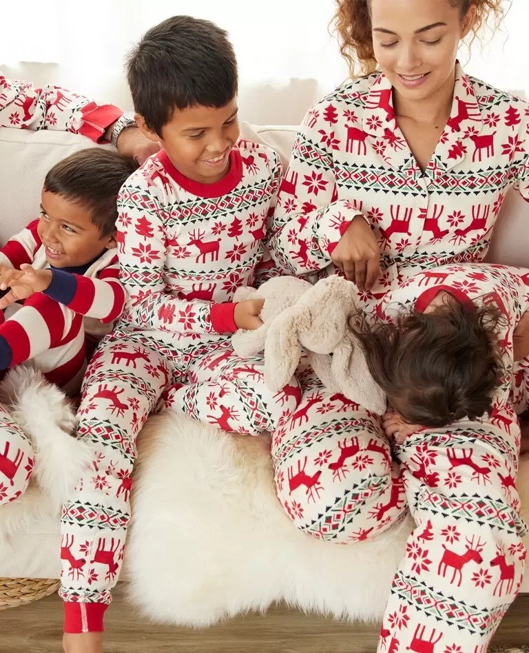 models wearing red reindeer printed pajamas