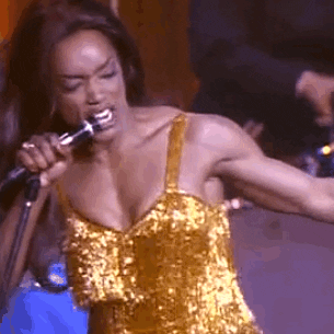 Angela singing and dancing on stage as Tina Turner