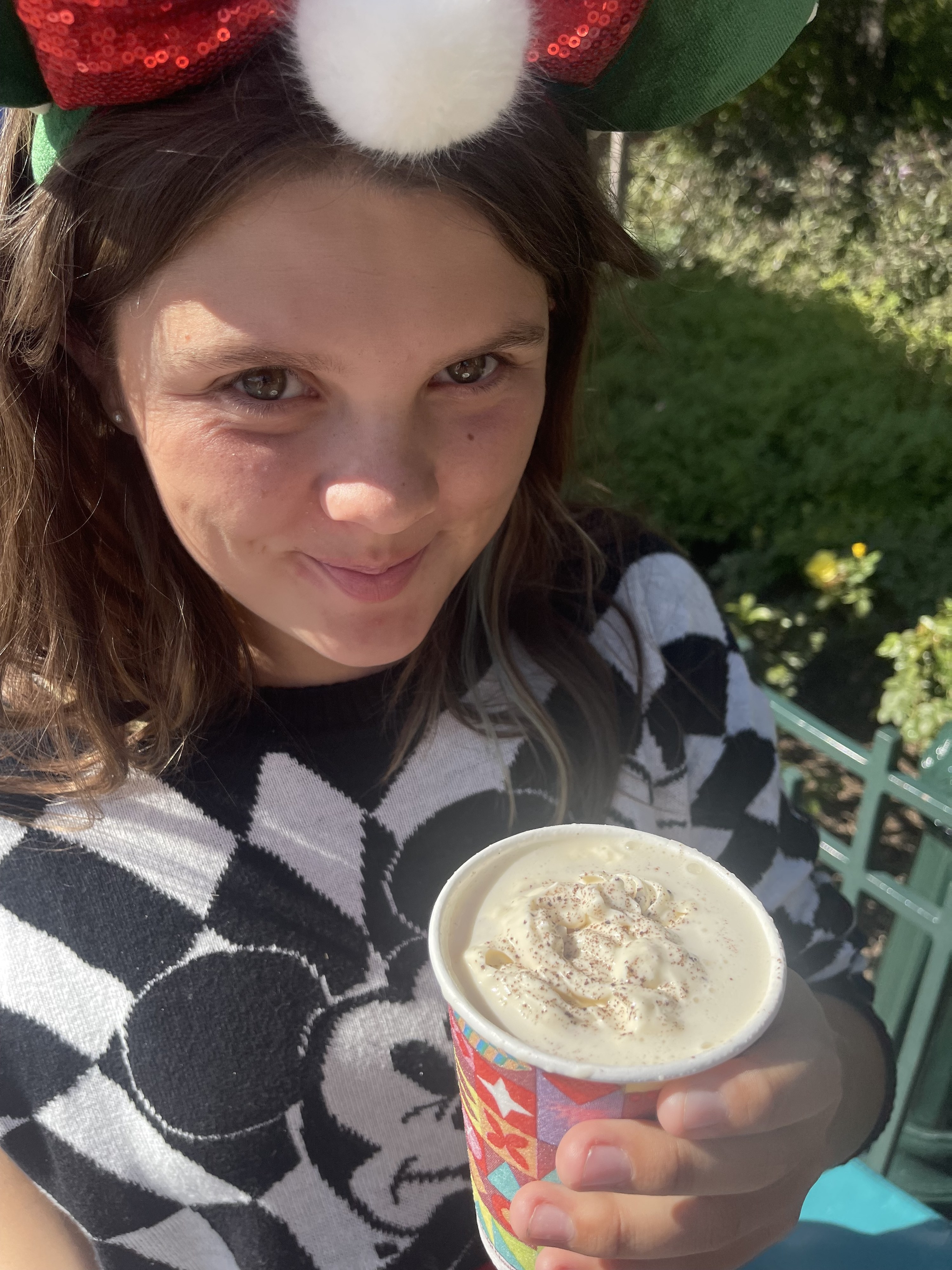 the author&#x27;s daughter smiling and holding a cup of hot chocolate