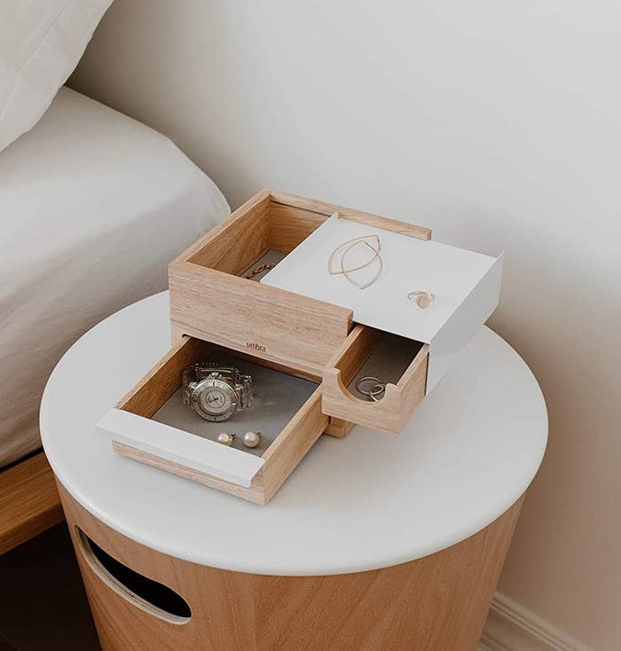 a multi-compartment jewelry box on a nightstand