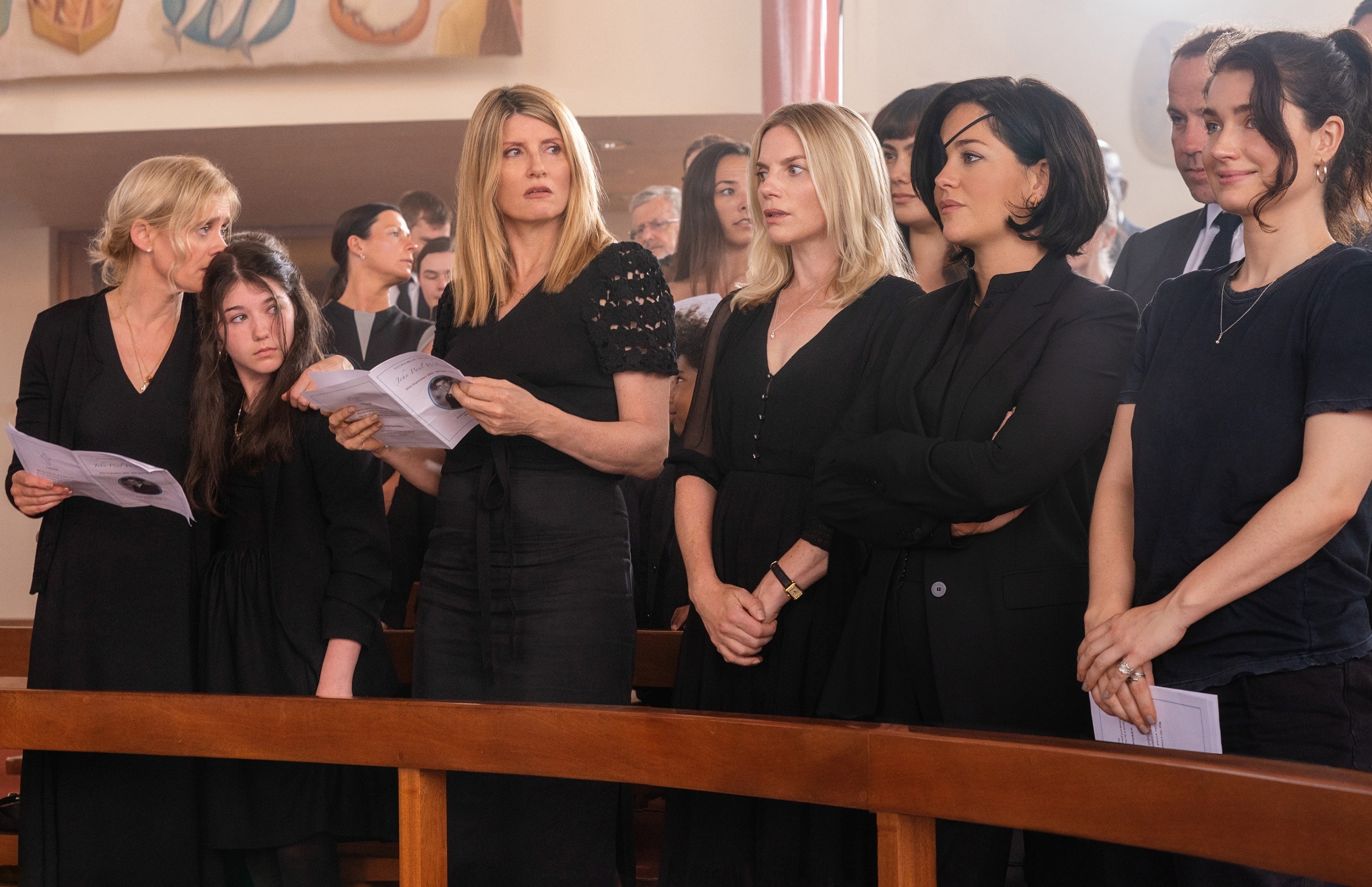 Sharon Horgan and four women stand in black at church at a funeral in the TV show Bad Sisters.