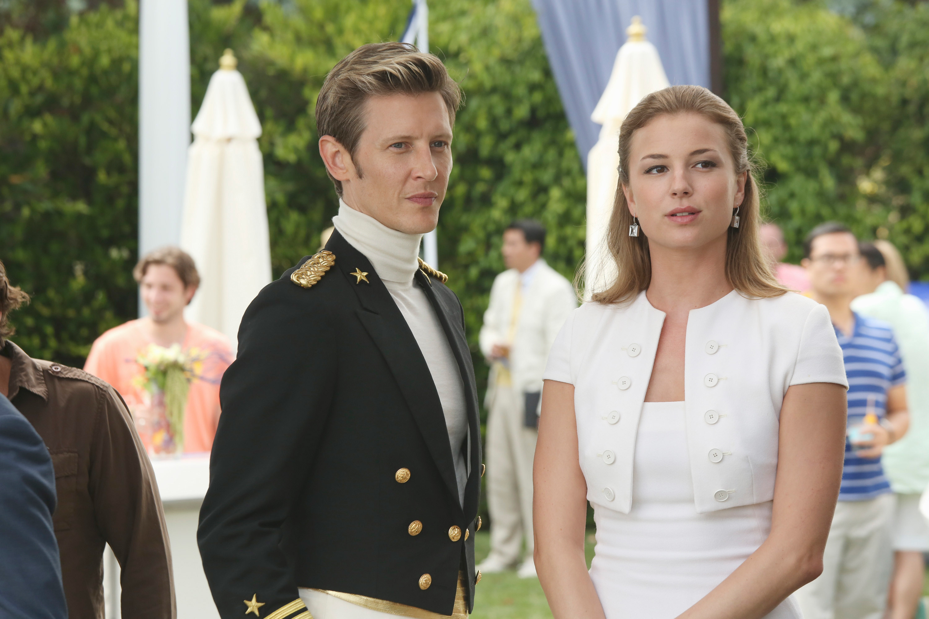 Emily VanCamp and Gabriel Mann stand outside at a party in the TV show Revenge.