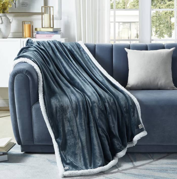 The blue reversible throw draped over couch