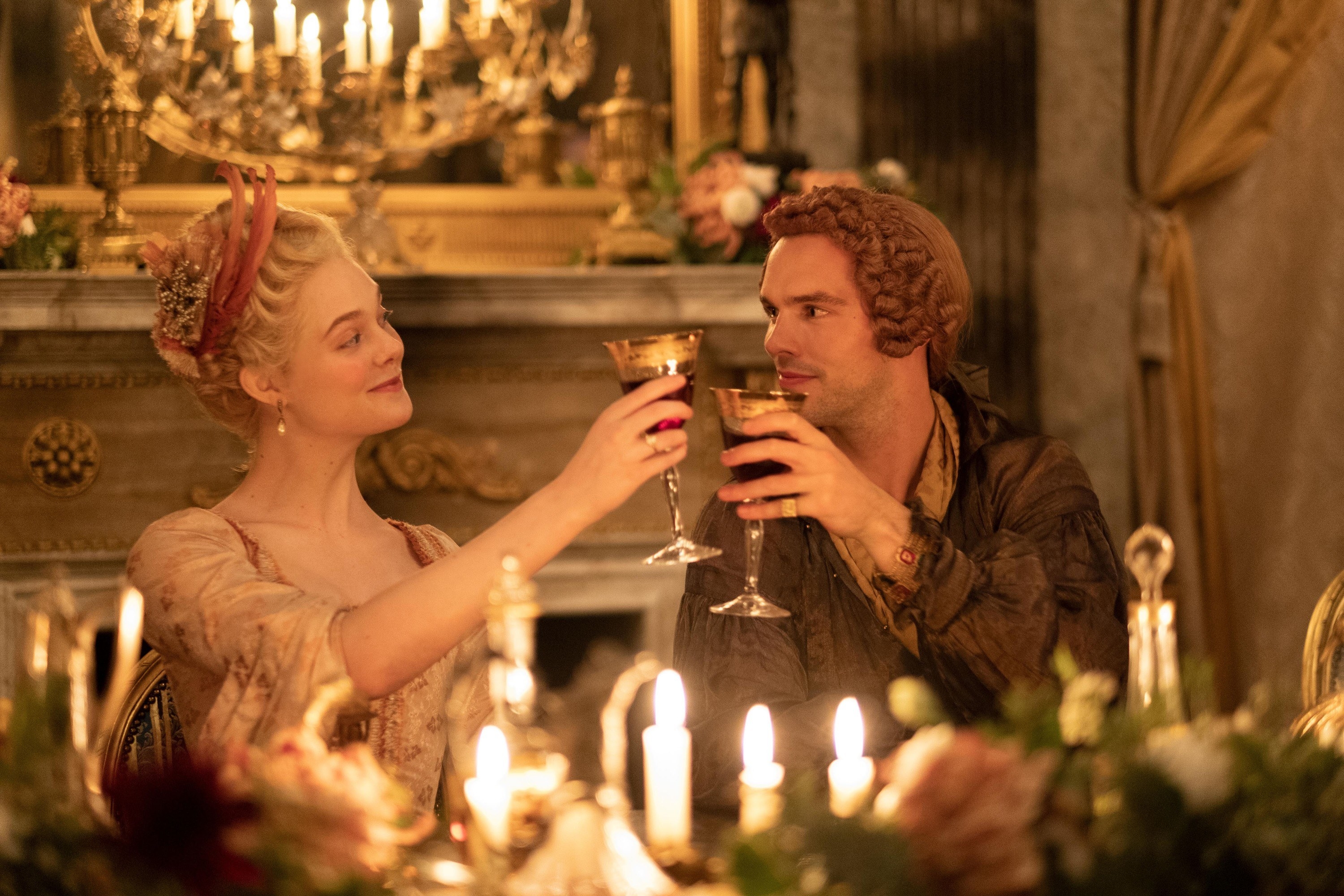 Elle Fanning and Nicholas Hoult cheers with red wine in The Great,