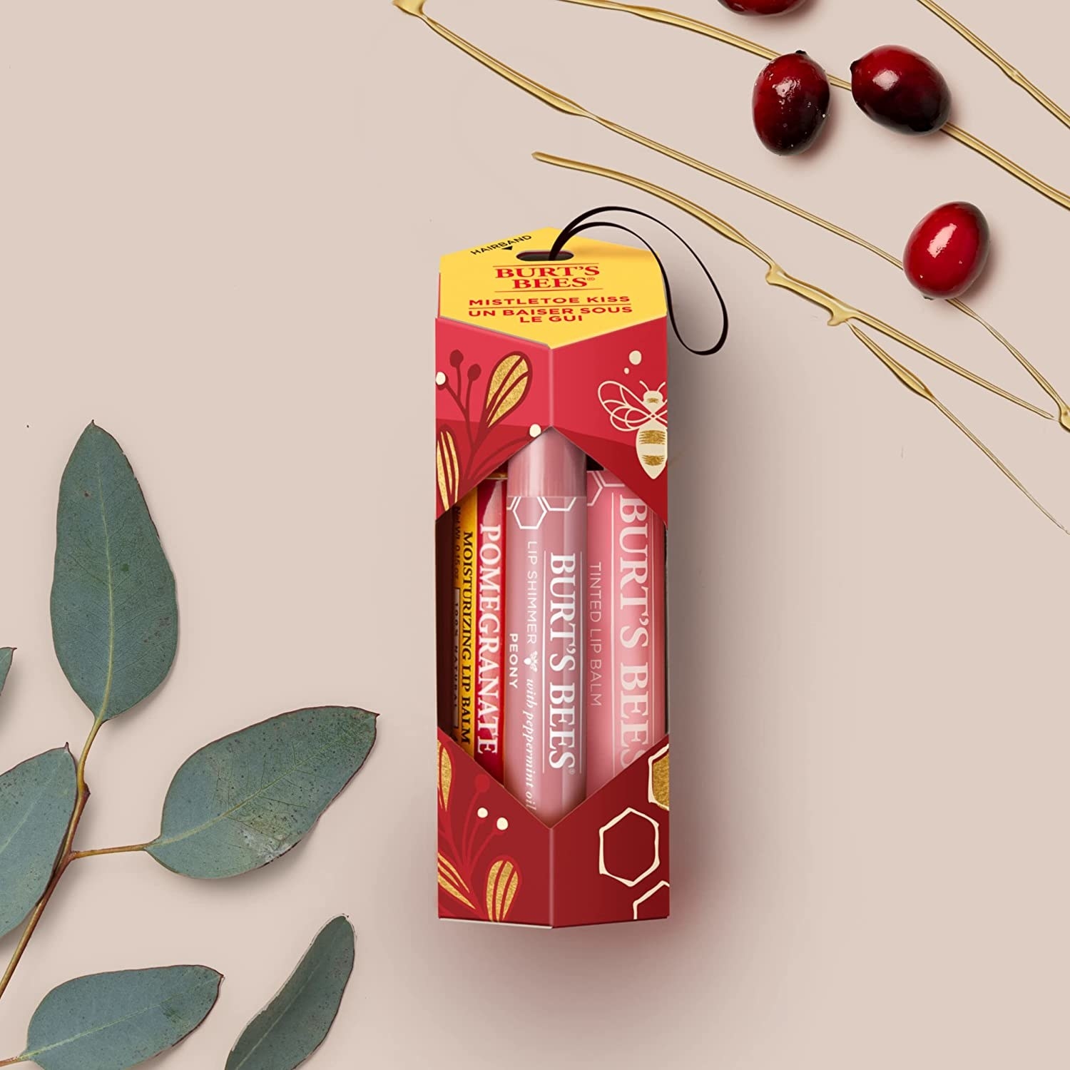 the pack of lip balms beside some leaves