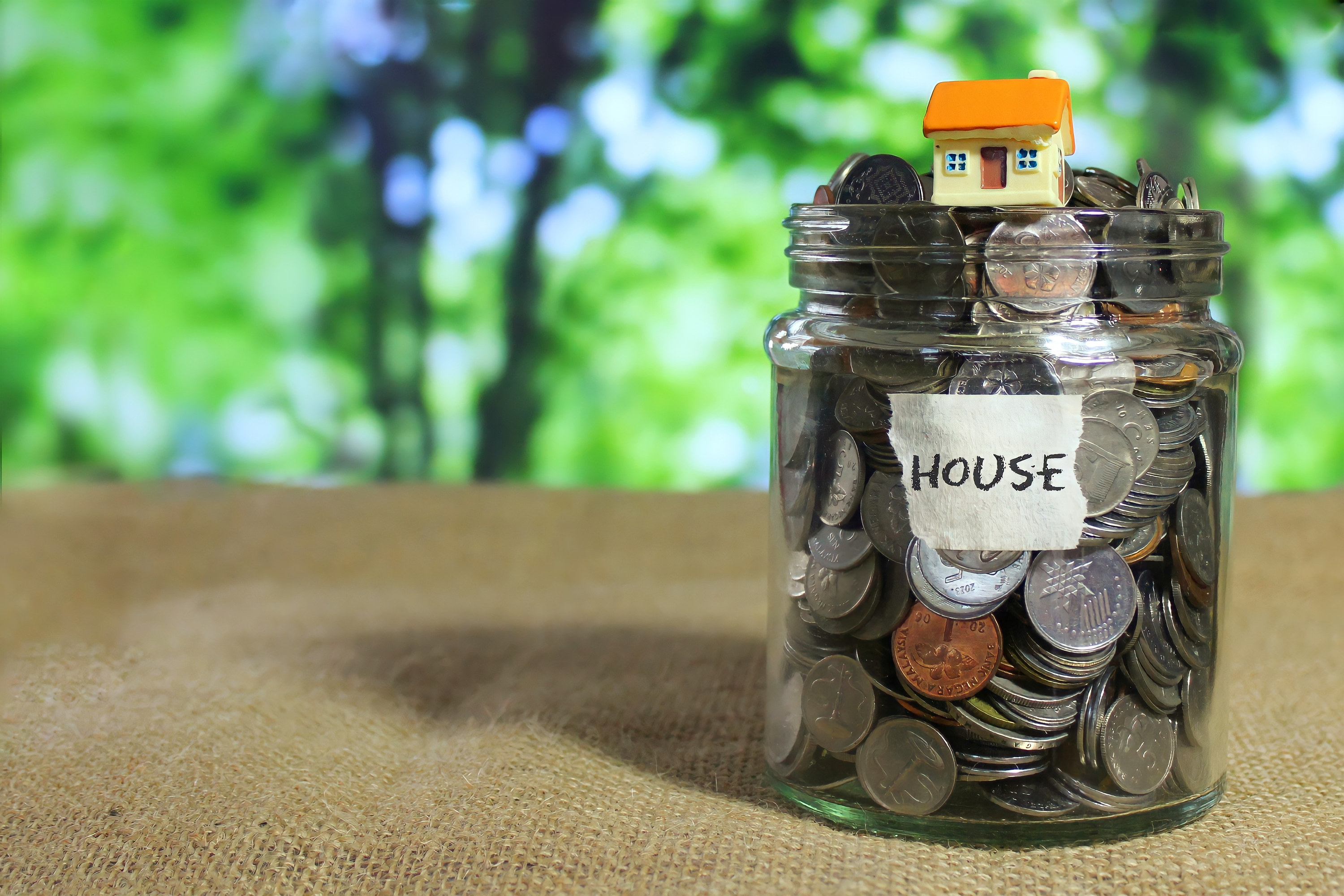 Jar of coins labeled &quot;house&quot;