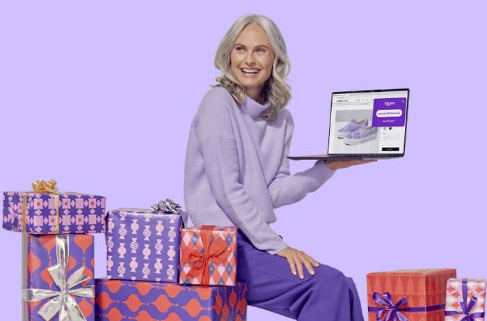 person with an open laptop sitting on presents
