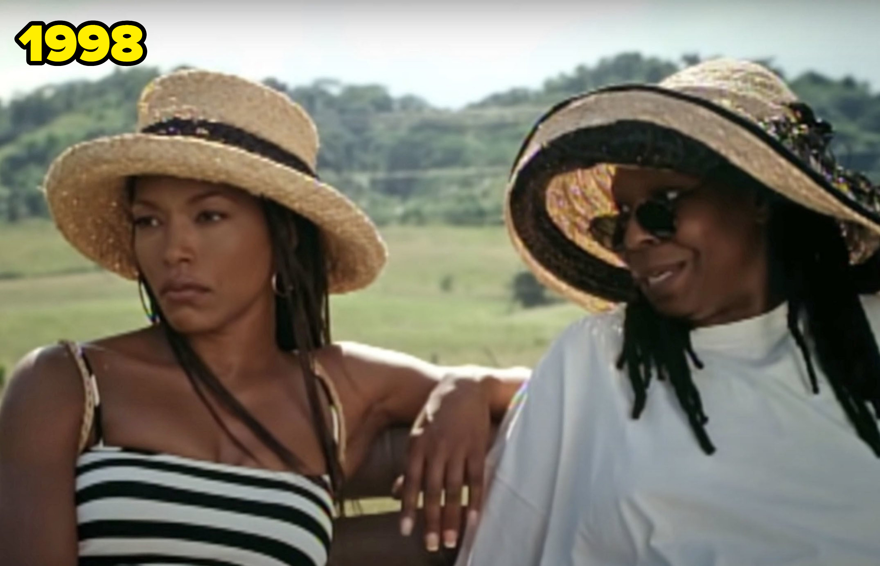 Angela and Whoopi, both wearing sun hats, sitting next to each other in a scene from the film