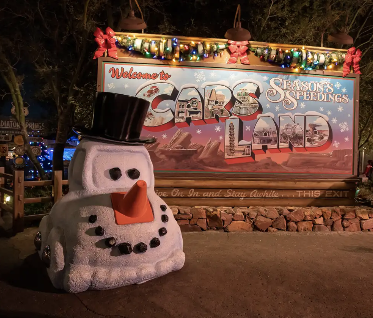 a sign that says &quot;Welcome to Cars Land — Season&#x27;s Greetings&quot;