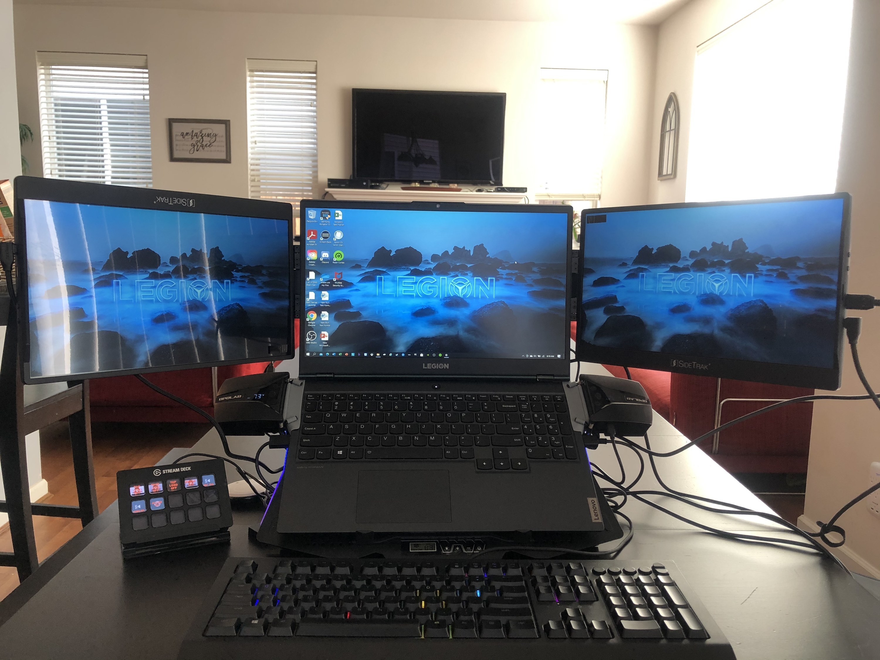 a reviewer&#x27;s desk set up with two of the sidetrak swivel monitors