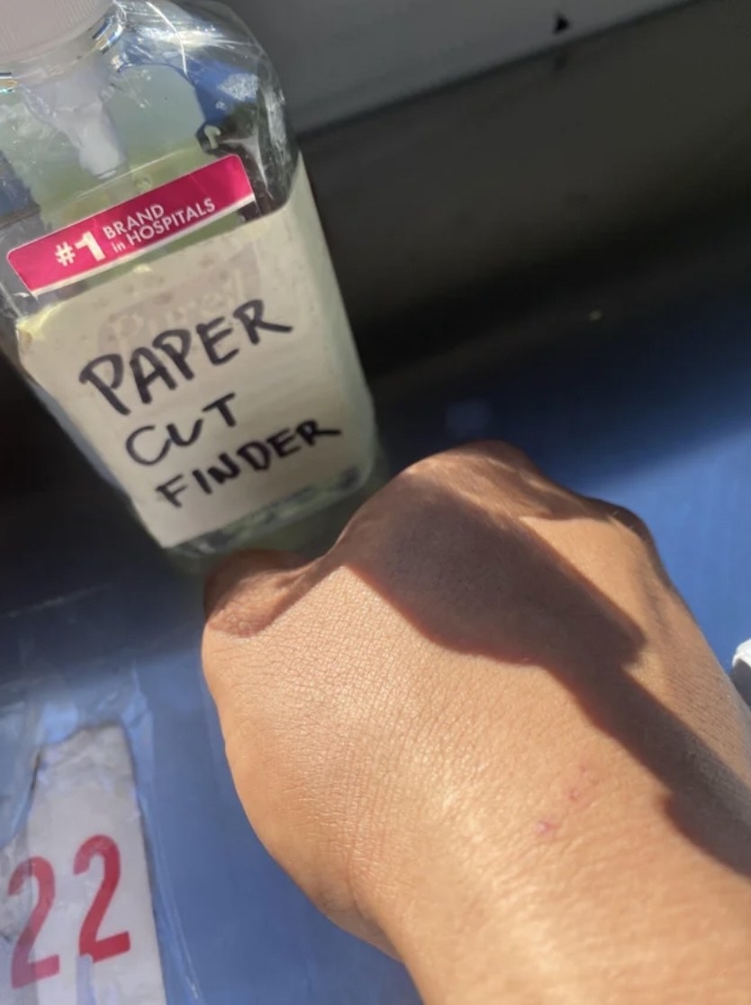 bottle with the words &quot;paper cut finder&quot; written for the label