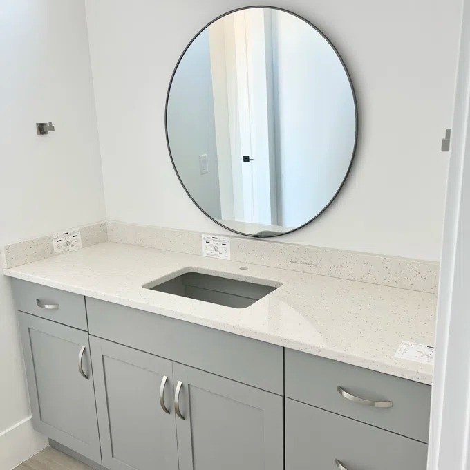 a reviewer photo of the mirror above a bathroom vanity