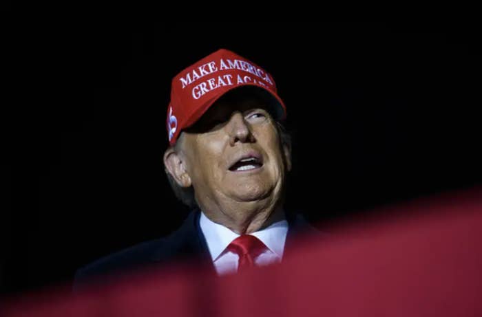 donald trump wearing his own lil red maga hat