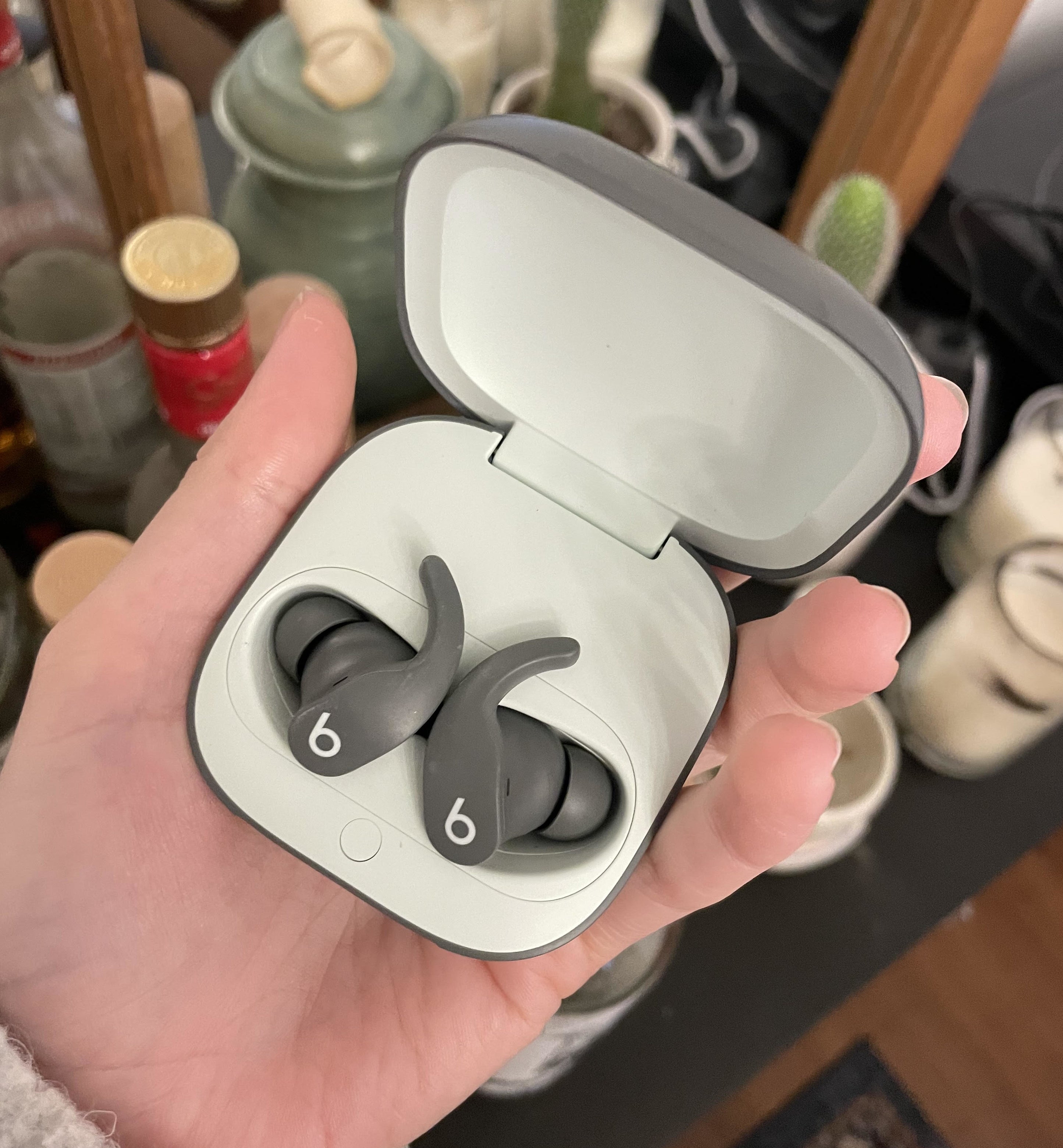 Alice holding the earbuds in their case