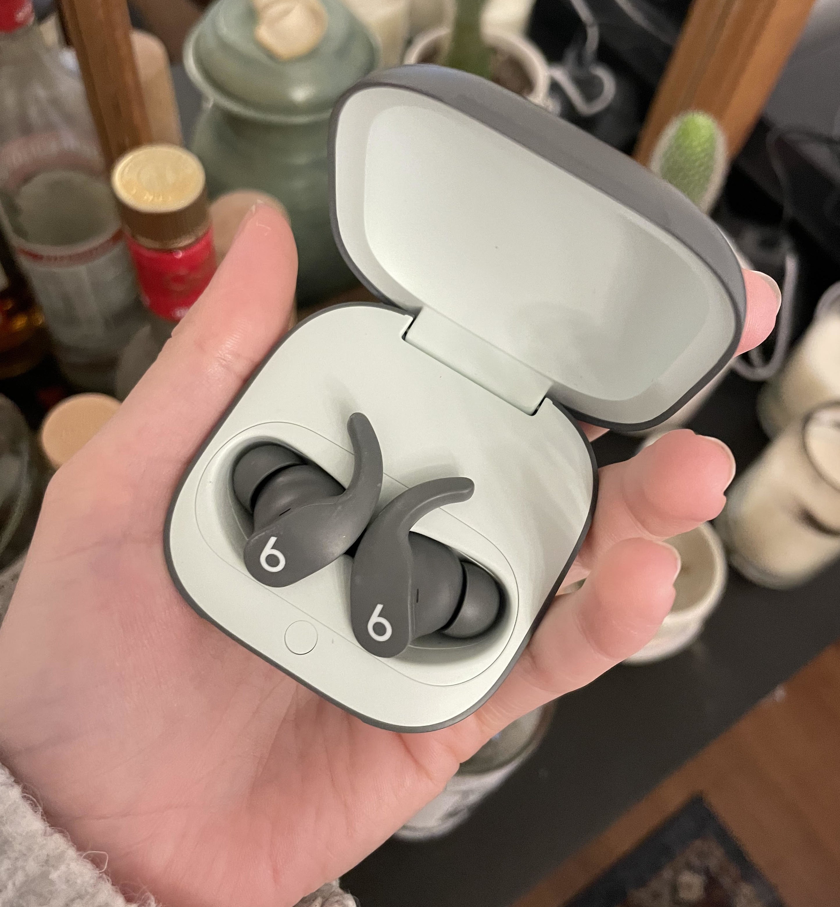 Alice holding the earbuds in their case