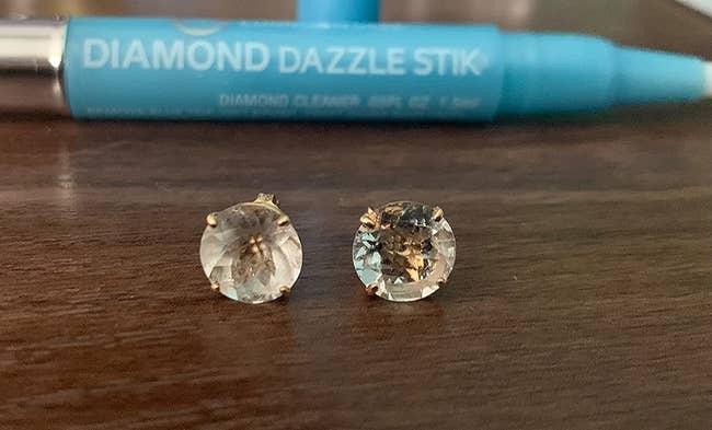 Reviewer's diamond earrings, one visibly not cleaned and one sparkling clean after using the diamond stick