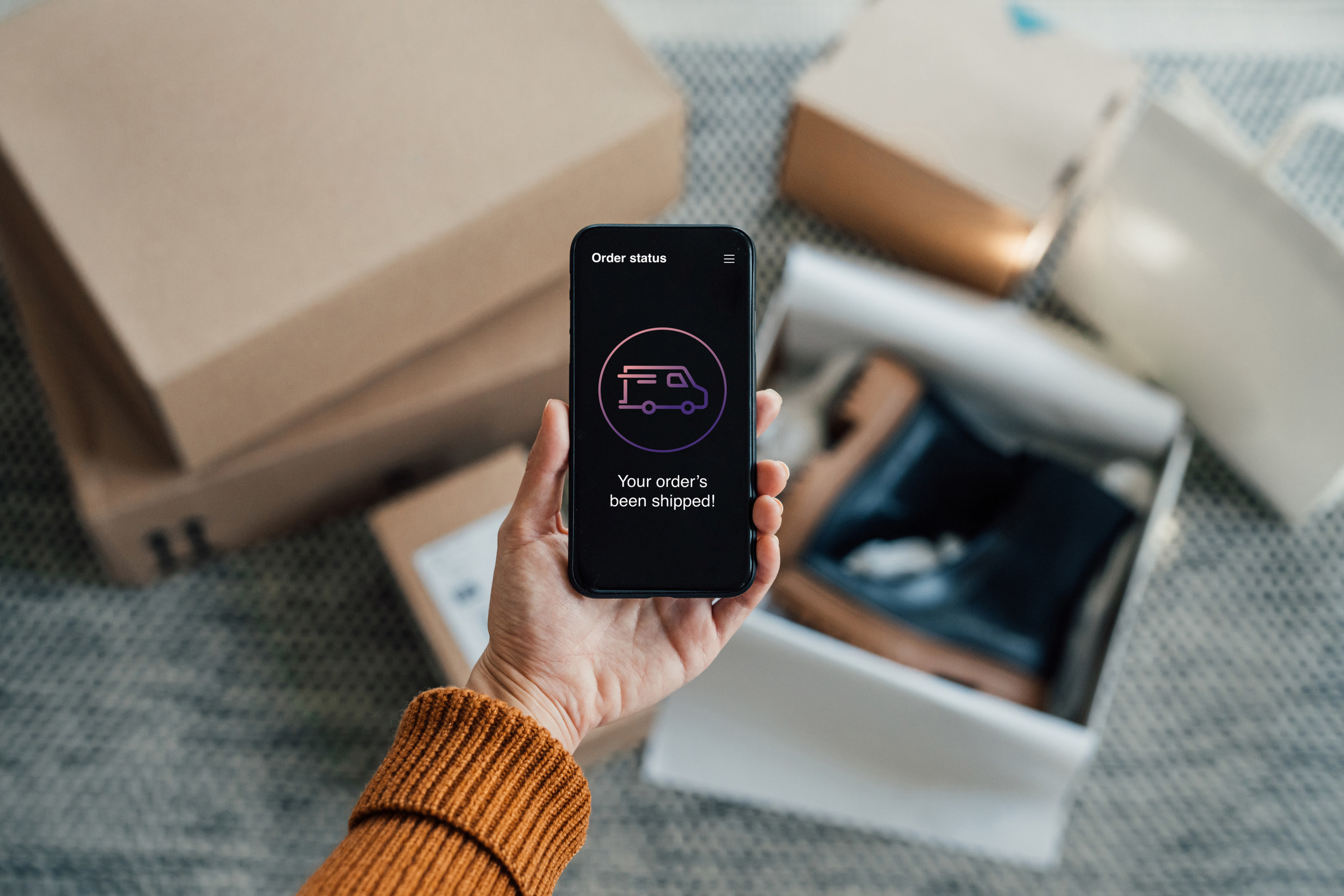 smartphone showing app open with message saying &quot;your order&#x27;s been shipped&quot;