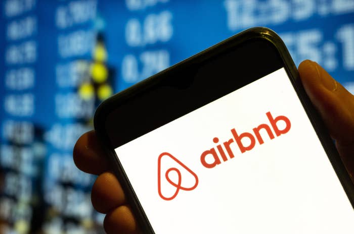 The Airbnb logo on a cellphone screen