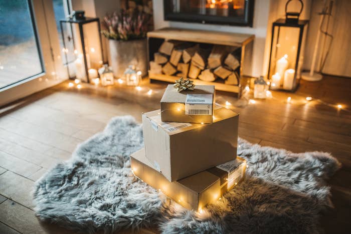 A stack of boxes with shipping labels in a festive room