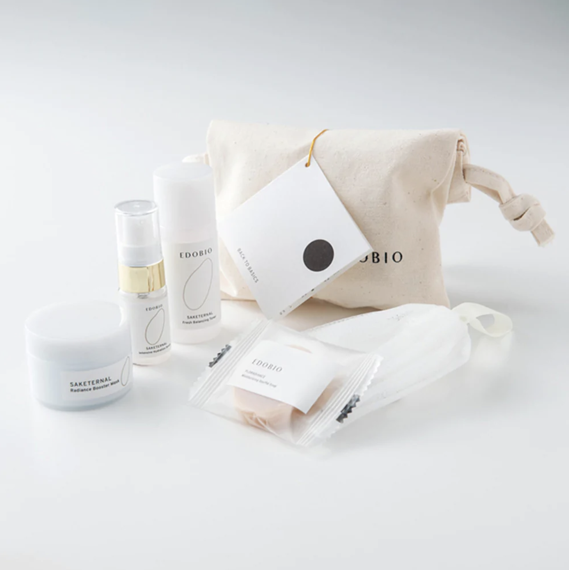 White packaged skincare creams, soap, and foaming net on white background